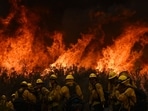 Firefighters during rescue operations at the Fairview wildfire near Hemet, California, on September 8, 2022. The last eight years were the warmest on record even with the cooling influence of a La Nina weather pattern since 2020, the European Union's climate monitoring service reported on January 10, 2023.(Patrick T. Fallon / AFP)