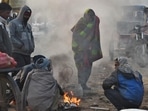 People warm themselves around a bonfire on a cold winter morning at Ghazipur market in New Delhi. (Raj K Raj / HT Photo) People warm themselves around a bonfire on a cold winter morning at Ghazipur market in New Delhi. (Raj K Raj / HT Photo)