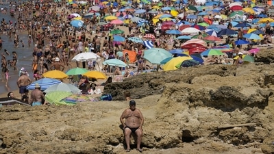 A man sits in the sun at Carcavelos beach, outside Lisbon, Portugal, on July 8, 2022. According to the Copernicus Climate Change Service, European temperatures have increased by more than twice the global average over the past 30 years, with the region showing the highest rate of increase of any continent on the globe, AFP reported. (Armando Franca / AP) A man sits in the sun at Carcavelos beach, outside Lisbon, Portugal, on July 8, 2022. According to the Copernicus Climate Change Service, European temperatures have increased by more than twice the global average over the past 30 years, with the region showing the highest rate of increase of any continent on the globe, AFP reported. (Armando Franca / AP)