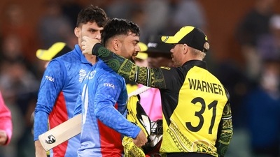 Australia's David Warner, right, embraces Afghanistan's Rashid Khan following their T20 World Cup cricket match in Adelaide (AP) Australia's David Warner, right, embraces Afghanistan's Rashid Khan following their T20 World Cup cricket match in Adelaide (AP)