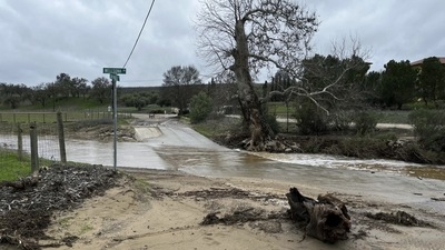Rain flows at the intersection of Wellsona Rd. and San Marcos Rd. near the San Marcos Creek on Wednesday, in San Miguel, Calif., captured about 15 minutes before a vehicle driven by Lindsy Doan and carrying her son, Kyle Doan, was swept away by rising floodwaters. The mother was eventually rescued, but her 5-year-old son remains missing. (AP) Rain flows at the intersection of Wellsona Rd. and San Marcos Rd. near the San Marcos Creek on Wednesday, in San Miguel, Calif., captured about 15 minutes before a vehicle driven by Lindsy Doan and carrying her son, Kyle Doan, was swept away by rising floodwaters. The mother was eventually rescued, but her 5-year-old son remains missing. (AP)