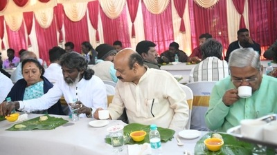 Bommai having breakfast with crematorium workers on Wednesday. (@BSBommai/Twitter)