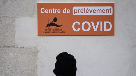 A man passes in front of a Covid 19 laboratory at the Saint-Jacques CHU (Centre Hospitalier Universitaire) in Nantes, western France. Long Covid symptoms fading for mild coronavirus infections, says new study (Photo by LOIC VENANCE / AFP)