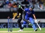 New Zealand's Mitchell Santner, left, attempts to run out India's Shikhar Dhawan during their one day international cricket match in Auckland, New Zealand, Friday, Nov. 25, 2022. (Andrew Cornaga/Photosport via AP) New Zealand's Mitchell Santner, left, attempts to run out India's Shikhar Dhawan during their one day international cricket match in Auckland, New Zealand, Friday, Nov. 25, 2022. (Andrew Cornaga/Photosport via AP)