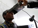 A man has his iris scanned for Aadhaar generation. 