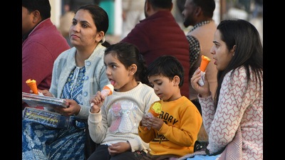 A family enjoying ice-cream at the Sector-17 Plaza in Chandigarh on a sunny Friday afternoon. As cloudy weather resumed later, the maximum temperature went down to 20.6°C. (Keshav Singh/HT)