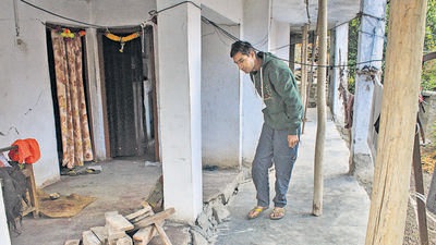 A man inspects the damages at his residence in Joshimath. (PTI)