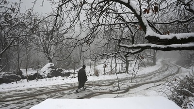 A man walks after fresh snowfall in the outskirts of Srinagar. (Waseem Andrabi/HT) A man walks after fresh snowfall in the outskirts of Srinagar. (Waseem Andrabi/HT)
