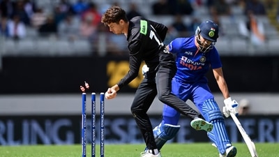 New Zealand's Mitchell Santner, left, attempts to run out India's Shikhar Dhawan during their one day international cricket match in Auckland, New Zealand, Friday, Nov. 25, 2022. (Andrew Cornaga/Photosport via AP) (AP)