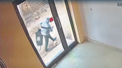Video clips show a man with a gun outside the ATM booth as cash van officials flee. (HT Photo) Video clips show a man with a gun outside the ATM booth as cash van officials flee. (HT Photo)
