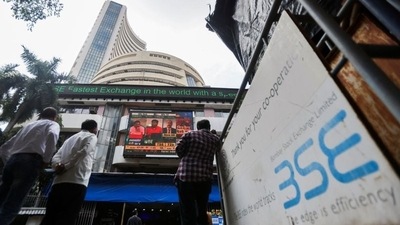 People stand outside the Bombay Stock Exchange (BSE) in Mumbai. (REUTERS)
