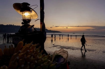 No visit to this island is complete without watching the sunset over Bali while sipping on a cocktail (File photo)