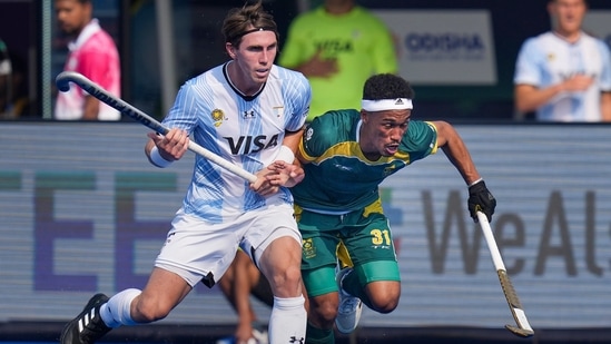 Argentina's Maico Casella and South Africa's Ryan Julius vie for the ball during the FIH Odisha Hockey Men's World Cup 2023 match between Argentina and South Africa, at Kalinga Hockey Stadium in Bhubaneswar, Friday, Jan. 13, 2023. (PTI Photo/Shailendra Bhojak)(PTI01_13_2023_000127B)(PTI) Argentina's Maico Casella and South Africa's Ryan Julius vie for the ball during the FIH Odisha Hockey Men's World Cup 2023 match between Argentina and South Africa, at Kalinga Hockey Stadium in Bhubaneswar, Friday, Jan. 13, 2023. (PTI Photo/Shailendra Bhojak)(PTI01_13_2023_000127B)(PTI)
