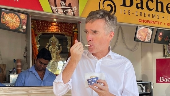 Britain's High Commissioner to India Alex Ellis eating an ice cream in Mumbai on Thursday.(@AlexWEllis/ Twitter)