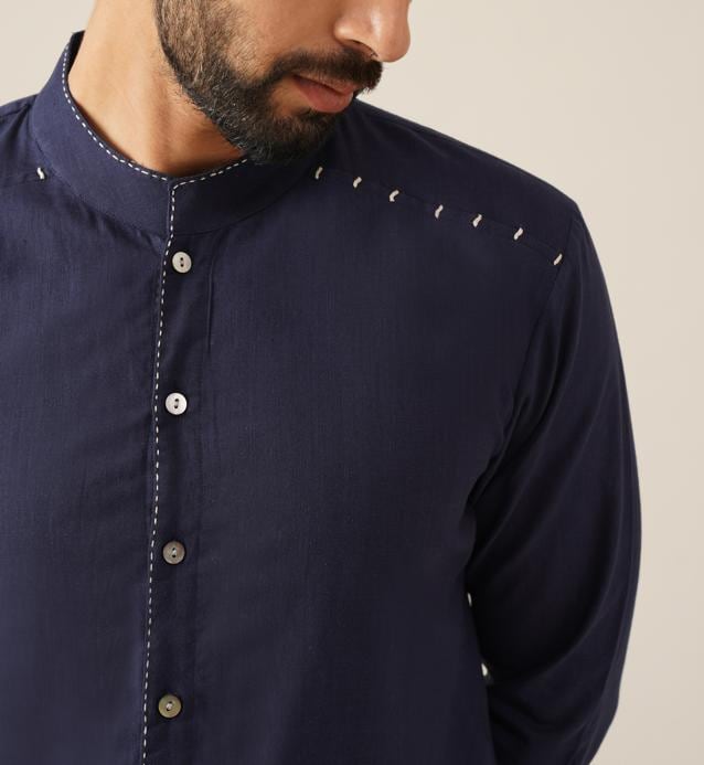 This contemporary and smart handmade shirt with a mandarin collar, contrasting buttons and thread work is ideal for a day or early evening occasion. (Indigo handwoven full sleeve cotton kurta shirt by Jaypore) This contemporary and smart handmade shirt with a mandarin collar, contrasting buttons and thread work is ideal for a day or early evening occasion. (Indigo handwoven full sleeve cotton kurta shirt by Jaypore)
