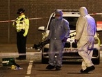 Forensics officers work at the scene of a shooting, the attack reportedly happened during a funeral at St Aloysius Church, in London, Britain, Saturday. 
