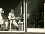 Covid In China: Security guards wearing personal protective equipment (PPE) amid the Covid-19 pandemic sit at an entrance of a building in Beijing.(AFP) Covid In China: Security guards wearing personal protective equipment (PPE) amid the Covid-19 pandemic sit at an entrance of a building in Beijing.(AFP)