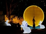 Lunar New Year 2023: A worker installs a lantern ahead of Chinese Lunar New Year. 