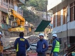 Officials prepare for the demolition of a hotel that has been marked unsafe on Saturday. (PTI) Officials prepare for the demolition of a hotel that has been marked unsafe on Saturday. (PTI)