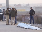 Police stand near the Bhalswa drain where a chopped body was reportedly found in New Delhi on Saturday. 