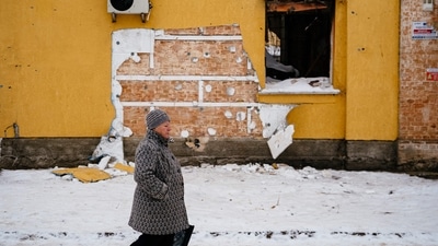 A woman is seen walking near a cut-off of the wall of a damaged building in the town of Gostomel on January 13, 2023, where Banksy had previously painted graffiti. "A group of people tried to steal a Banksy mural. They cut out the work from the wall of a house destroyed by the Russians," Kyiv governor Oleksiy Kuleba said, AFP reported. (Dimitar Dilkoff / AFP) A woman is seen walking near a cut-off of the wall of a damaged building in the town of Gostomel on January 13, 2023, where Banksy had previously painted graffiti. "A group of people tried to steal a Banksy mural. They cut out the work from the wall of a house destroyed by the Russians," Kyiv governor Oleksiy Kuleba said, AFP reported. (Dimitar Dilkoff / AFP)