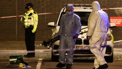 Forensics officers work at the scene of a shooting, the attack reportedly happened during a funeral at St Aloysius Church, in London, Britain, Saturday. (REUTERS)