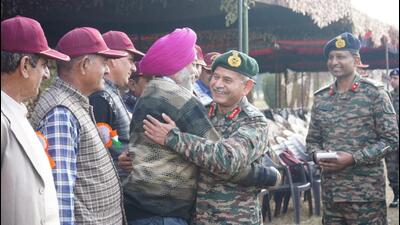 Northern army commander Lt Gen Upendra Dwivedi hugs an ex-serviceman during veterans’ day celebrations in Rajouri on Saturday. (HT Photo)