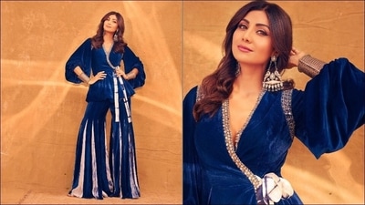 Shilpa Shetty in blue velvet peplum jacket-pants is a fashion treat for sore eyes. Her peplum jacket teamed with a pair of kalidar bell bottoms pants is stunning and is an ideal inspiration if you want to ditch traditional suits and sarees and is in a mood of experimentation. She accessorised her look with a pair of gallant oxidized earrings and bracelet.&nbsp; (Instagram/theshilpashetty)