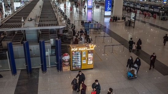 Covid In China: Travelers at Beijing Capital International Airport in Beijing, China. (Bloomberg)