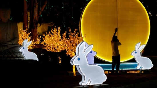 Lunar New Year 2023: A worker installs a lantern ahead of Chinese Lunar New Year. (REUTERS)