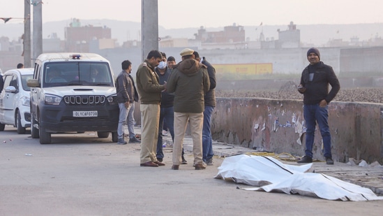 Police stand near the Bhalswa drain where a chopped body was reportedly found in New Delhi on Saturday. (PTI)