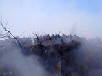 Nepal plane crash: Locals watch the wreckage of a passenger plane in Pokhara, Nepal.(AP) Nepal plane crash: Locals watch the wreckage of a passenger plane in Pokhara, Nepal.(AP)