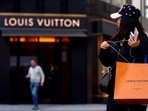A woman with a Louis Vuitton-branded shopping bag.(Reuters)