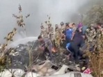 Rescuers work at the site of a plane crash in Pokhara, Nepal January 15, 2023, in this screen grab taken from a handout video.