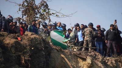Nepal Plane Crash: Locals watch the wreckage of a passenger plane in Pokhara, Nepal. (AP) Nepal Plane Crash: Locals watch the wreckage of a passenger plane in Pokhara, Nepal. (AP)