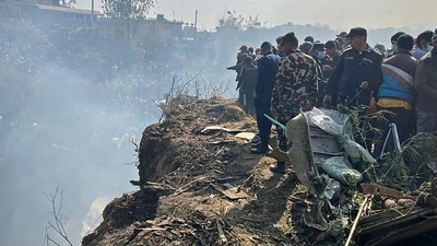 Passenger Aircraft Crash In Nepal: Rescuers and onlookers gather at the site of a plane crash in Pokhara. (AFP) Passenger Aircraft Crash In Nepal: Rescuers and onlookers gather at the site of a plane crash in Pokhara. (AFP)