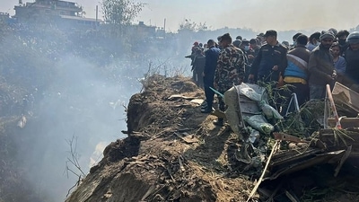 Rescuers and onlookers gather at the site of a plane crash in Pokhara. (AFP) Rescuers and onlookers gather at the site of a plane crash in Pokhara. (AFP)