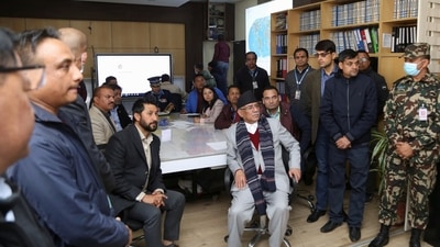Nepal's Prime Minister Pushpa Kamal Dahal watches a live television broadcast. &nbsp; (via REUTERS)