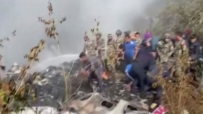 Nepal Plane Crash: Rescuers work at the site of a plane crash in Pokhara, Nepal. (Reuters)