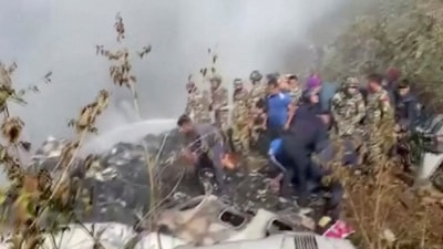 Rescuers work at the site of a plane crash in Pokhara, Nepal January 15, 2023, in this screen grab taken from a handout video. (via REUTERS)