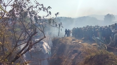 Crowds gather at the crash site of an aircraft carrying 72 people in Pokhara in western Nepal January 15, 2023. (via Reuters)