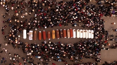 Residents surround coffins during a vigil for the more than a dozen people who died during the unrest in Juliaca, Peru. (AP) Residents surround coffins during a vigil for the more than a dozen people who died during the unrest in Juliaca, Peru. (AP)