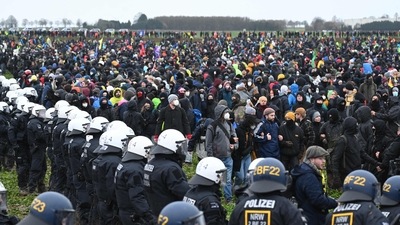 Police face protesters during a large-scale protest to stop the demolition of the village Luetzerath to make way for an open-air coal mine extension on Saturday (AFP) Police face protesters during a large-scale protest to stop the demolition of the village Luetzerath to make way for an open-air coal mine extension on Saturday (AFP)