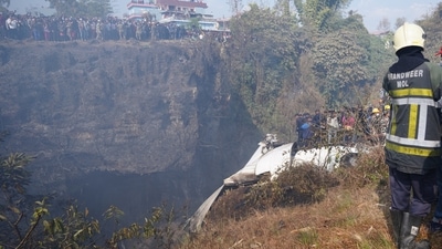 Rescue teams work to retrieve bodies from the wreckage at the crash site of an aircraft carrying 72 people in Pokhara in western Nepal January 15, 2023. (REUTERS/Rohit Giri)
