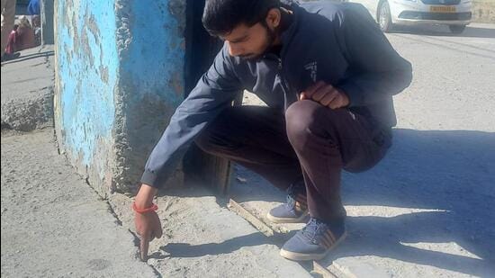 A staff family member living in the Municipal Board building in Joshimath checking the cracks. (Sourced)