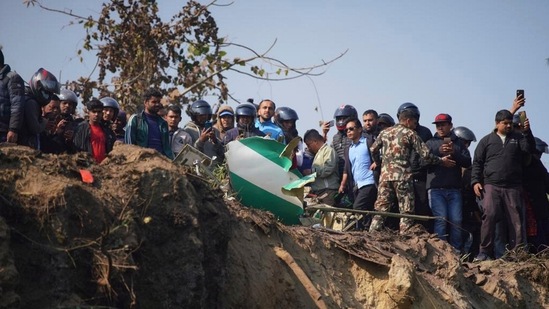 Nepal Plane Crash: Locals watch the wreckage of a passenger plane in Pokhara, Nepal.(AP)