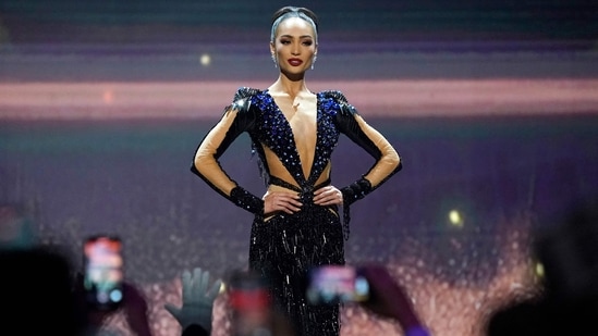 R'Bonney's gown features a deep waist-length neckline, heavy embellishments on the shoulder pads, and a figure-hugging silhouette. She styled it with shimmering diamond earrings and a sleek updo. (AFP)