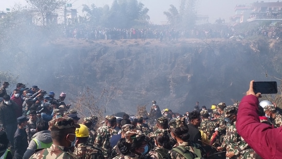 Nepal Plane Crash: Crowds gather as rescue teams work to retrieve bodies at the crash site of an aircraft carrying 72 people in Pokhara.(Reuters)