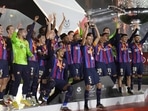 Barcelona players celebrate with a trophy after they won the final of the Spanish Super Cup between Barcelona and Real Madrid, in Riyadh, Saudi Arabia(AP) Barcelona players celebrate with a trophy after they won the final of the Spanish Super Cup between Barcelona and Real Madrid, in Riyadh, Saudi Arabia(AP)