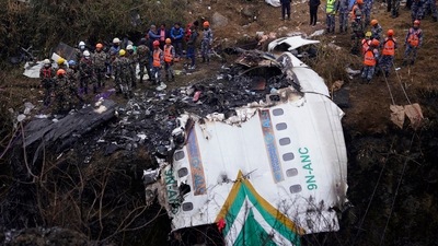 Rescuers scour the crash site in the wreckage of a passenger plane in Pokhara, Nepal, Monday. (AP) Rescuers scour the crash site in the wreckage of a passenger plane in Pokhara, Nepal, Monday. (AP)